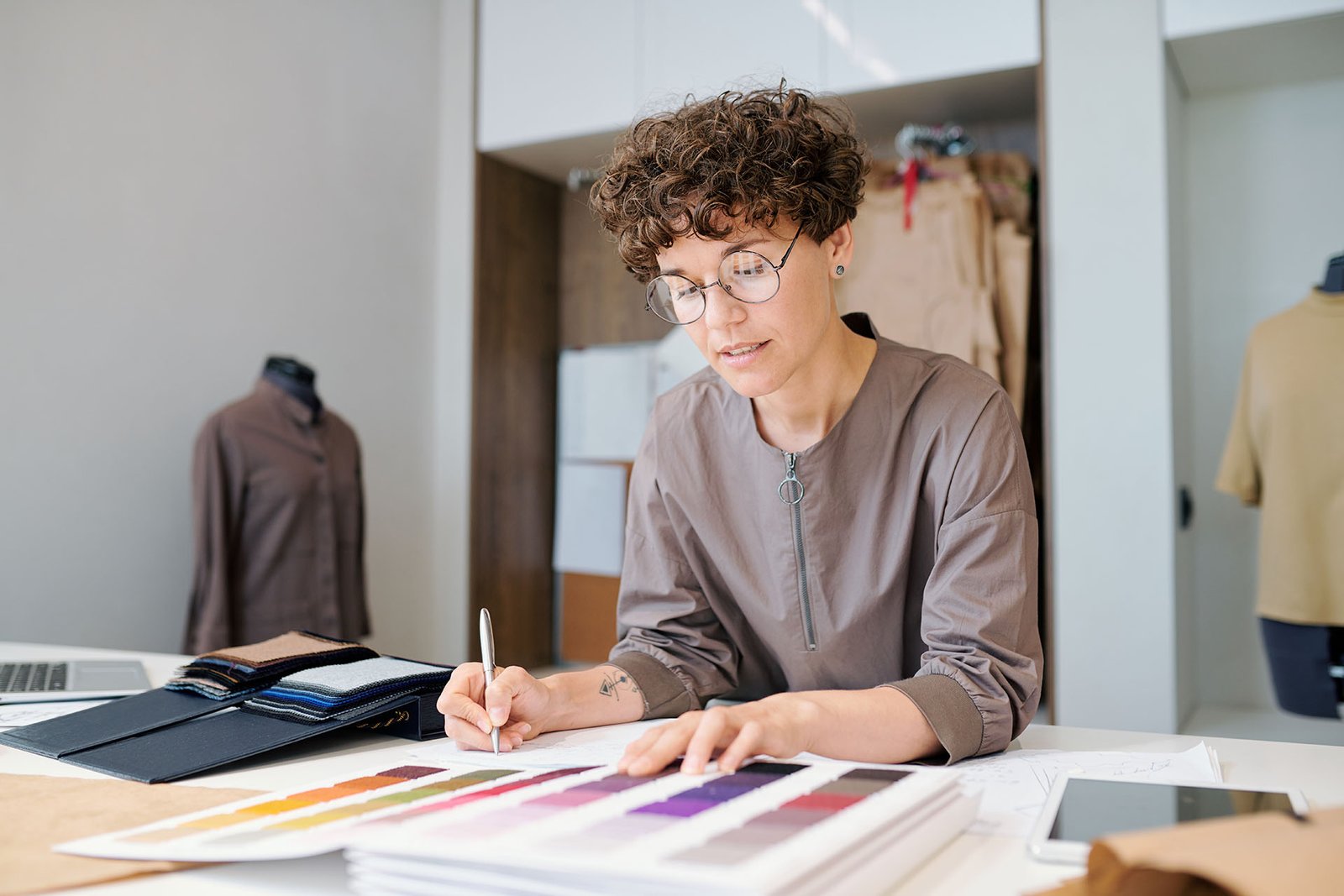 Young businesswoman looking through collectioln of textile samples